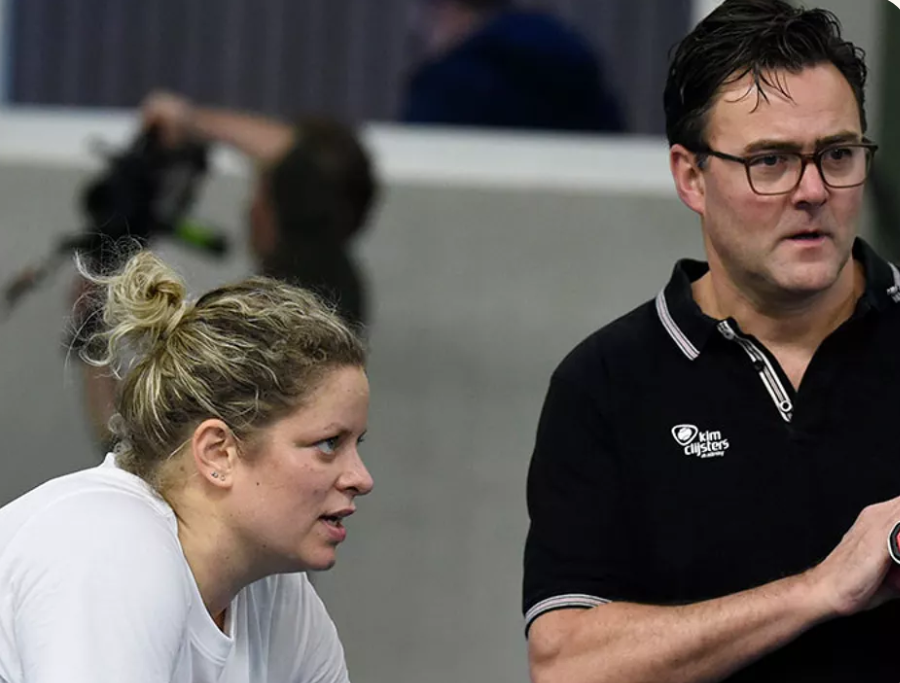 Carl Maes talking with Kim Clijsters courtside during a practice session